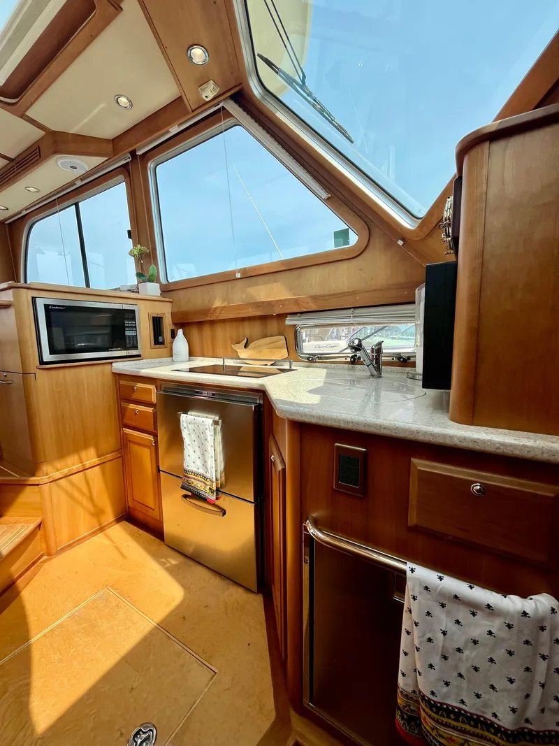 Slide: The Image of Luxurious 2010 Sabre 40 Sedan yacht interior with modern kitchen and large windows. - 25