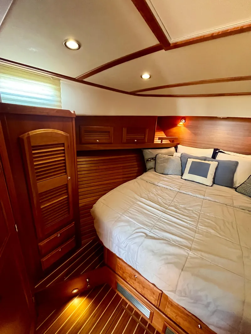 Slide: The Image of Cozy bedroom interior of 2010 Sabre 40 Sedan yacht with wood accents and soft lighting. - 30
