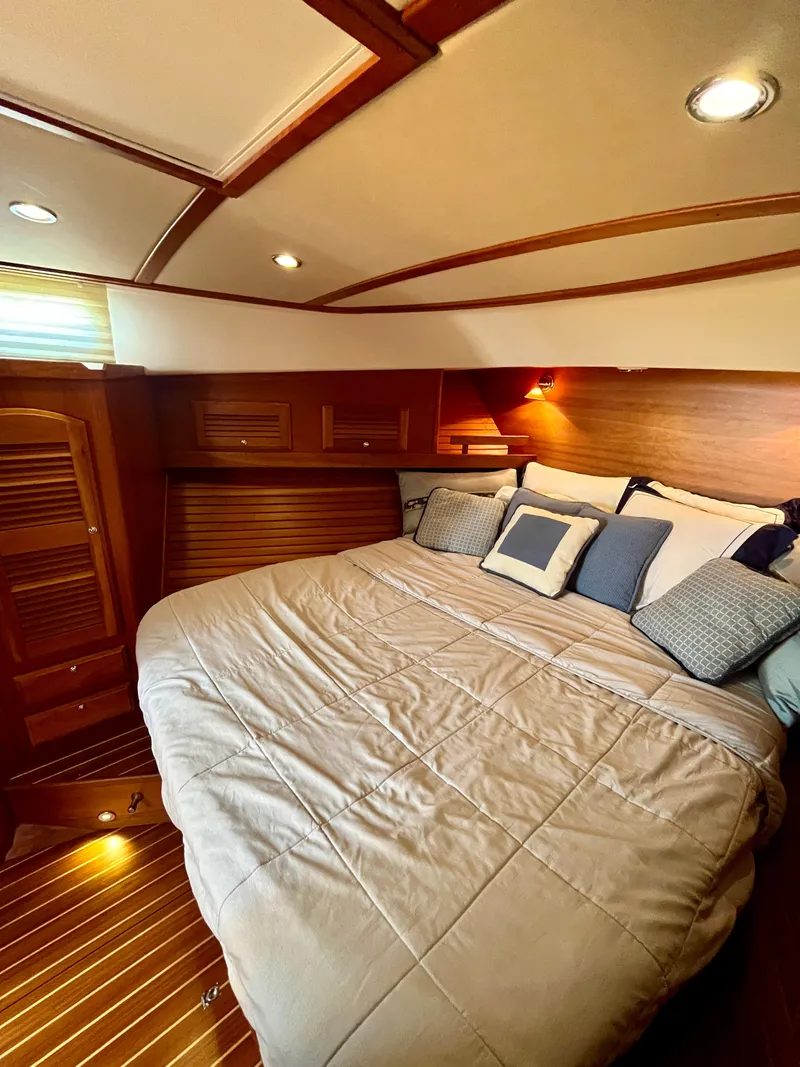 Slide: The Image of Luxurious cabin interior of 2010 Sabre 40 Sedan with cozy bedding and wooden accents. - 31