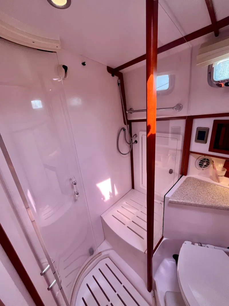 Slide: The Image of 2010 Sabre 40 Sedan yacht bathroom with shower, toilet, and countertop. - 35
