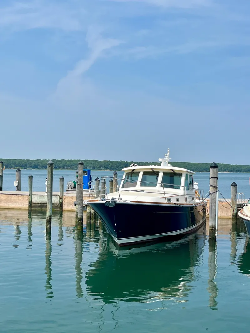 Slide: The Image of 2010 Sabre 40 Sedan docked at a marina on a sunny day. - 4