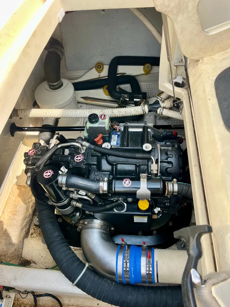 Slide: The Image of Engine compartment of a 2010 Sabre 40 Sedan boat, showcasing mechanical components and hoses. - 43