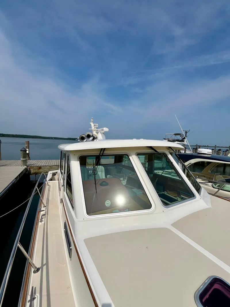 Slide: The Image of 2010 Sabre 40 Sedan docked by the water under a clear blue sky. - 47