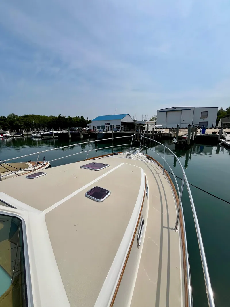 Slide: The Image of 2010 Sabre 40 Sedan yacht docked at a marina under a clear sky. - 48