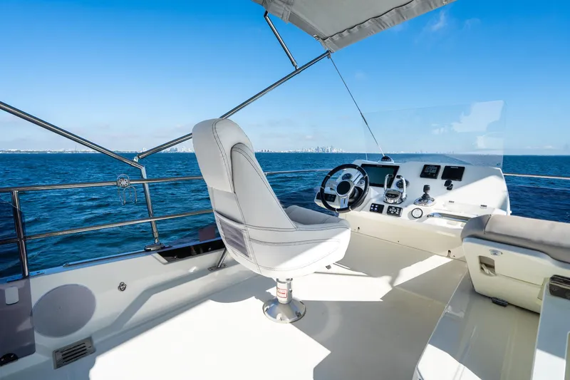 Slide: The Image of Luxury yacht helm on a 2020 Prestige 420, overlooking the ocean. - 16
