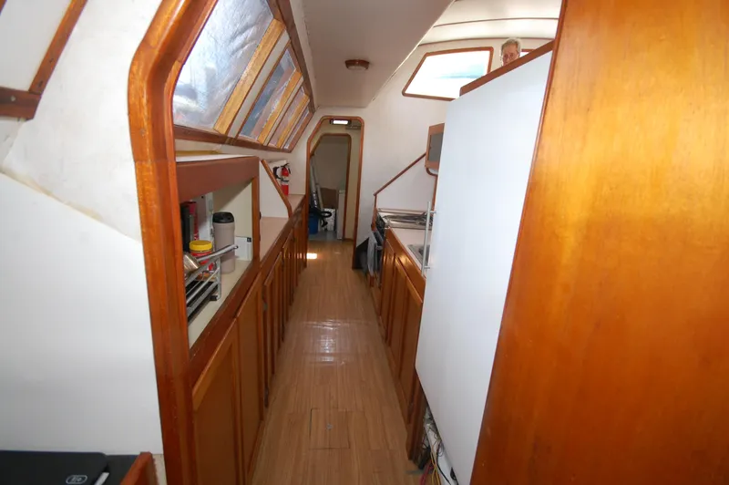 Slide: The Image of Interior of 2003 Leopard Morrelli & Melvin Catamaran with wooden cabinetry and skylights. - 10