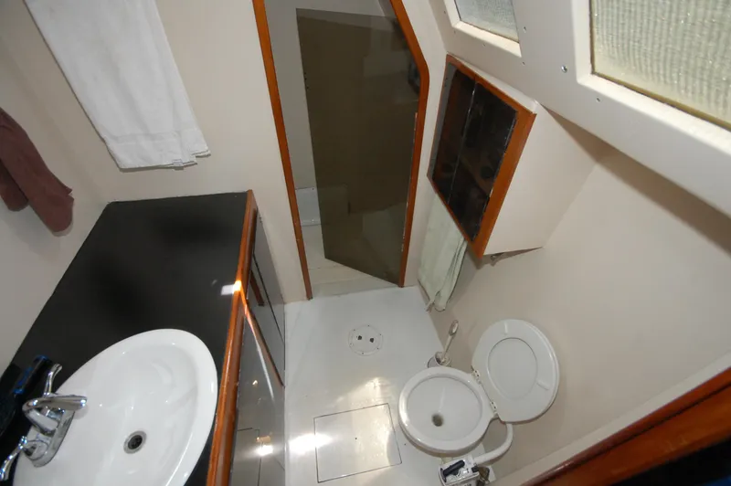 Slide: The Image of Bathroom interior of 2003 Custom Leopard Morrelli & Melvin Catamaran, featuring sink and toilet. - 17