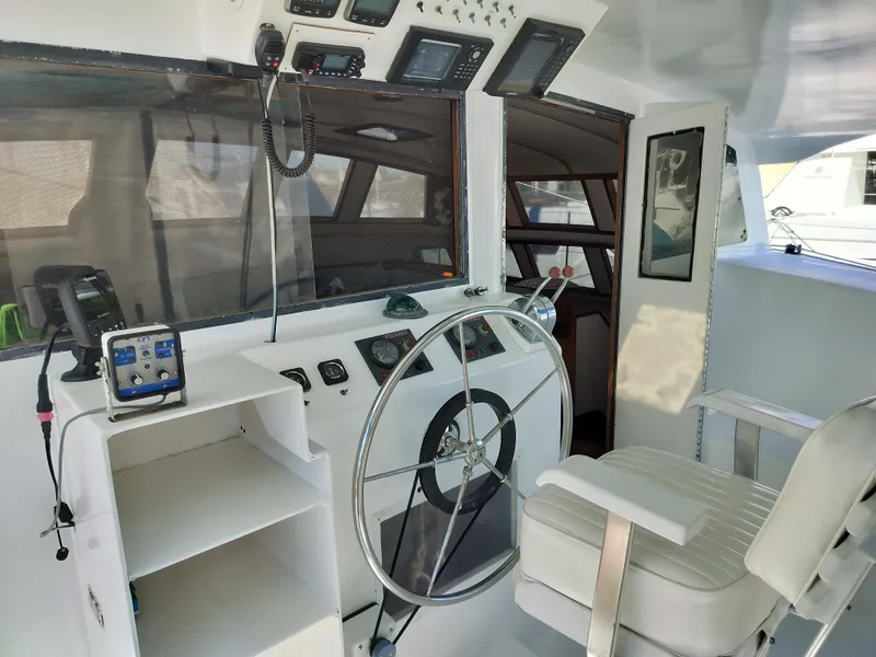 Slide: The Image of Helm station of 2003 Leopard Morrelli & Melvin Catamaran with steering wheel and navigation equipment. - 22