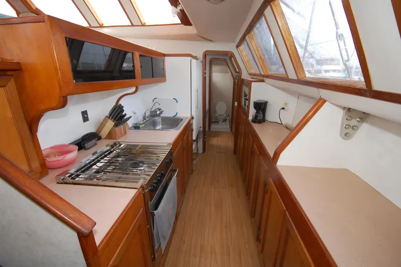 Slide: The Image of 2003 Custom Leopard Morrelli & Melvin Catamaran kitchen with wood cabinetry and modern appliances. - 5
