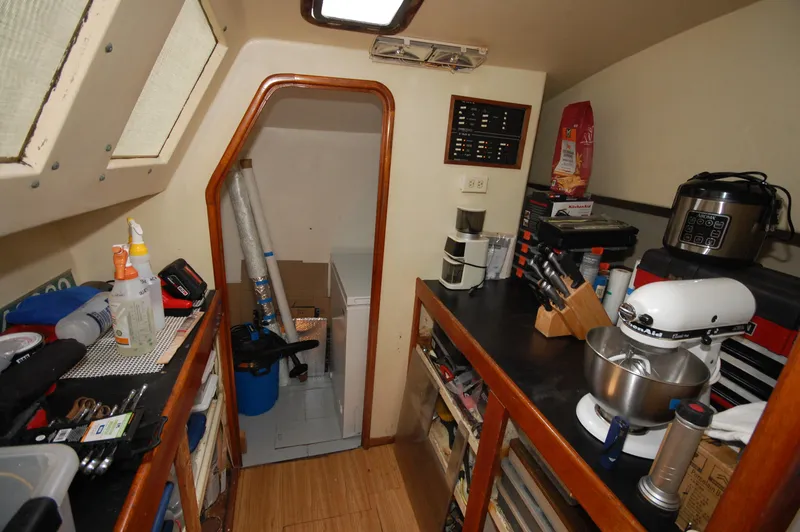 Slide: The Image of Compact kitchen area in a 2003 Leopard Morrelli & Melvin Catamaran with appliances and storage. - 6