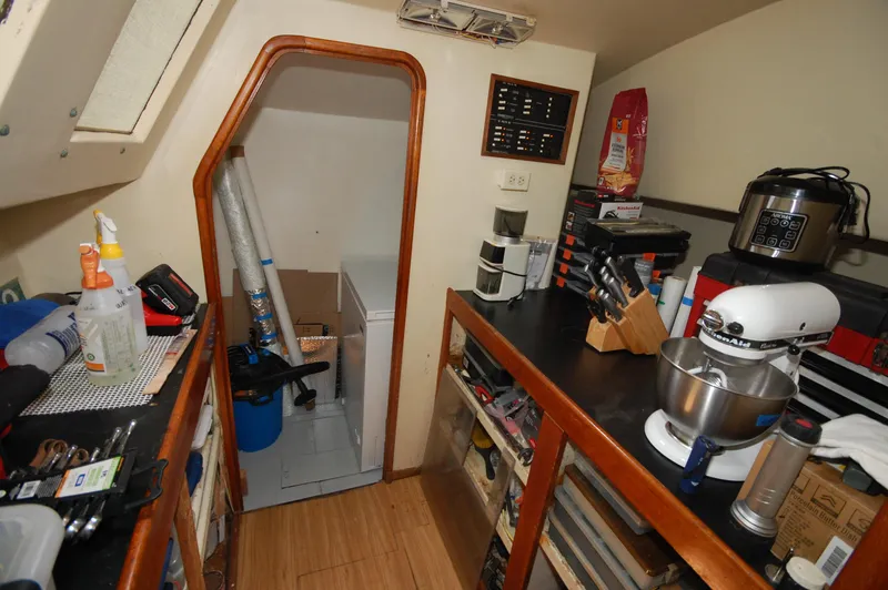 Slide: The Image of Interior of 2003 Leopard Morrelli & Melvin Catamaran with kitchen appliances and storage. - 7