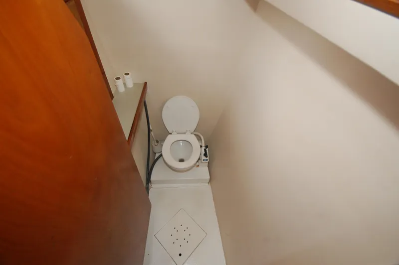 Slide: The Image of Compact bathroom in 2003 Leopard Morrelli & Melvin Catamaran with toilet and wooden door. - 9