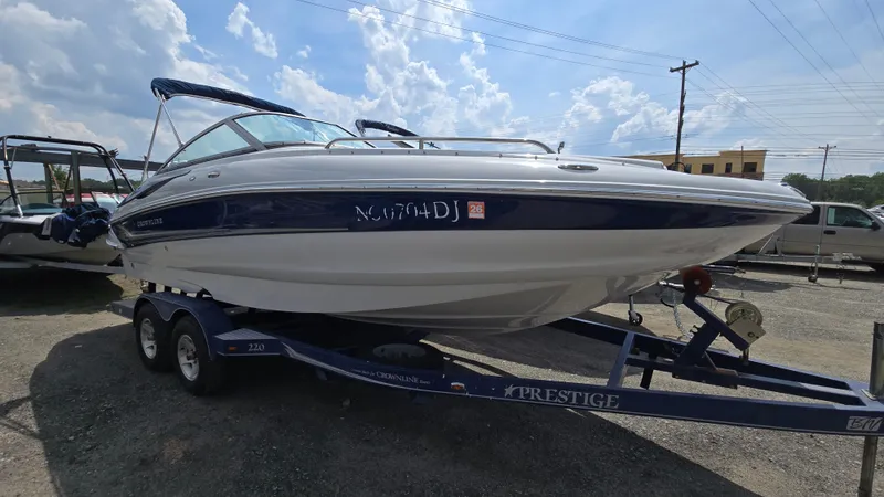 The Image of 2007 Crownline 220EX boat on trailer under a partly cloudy sky. - 0
