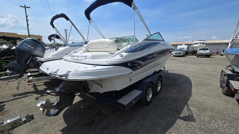 Slide: The Image of 2007 Crownline 220EX boat on trailer, parked outdoors under clear blue sky. - 1