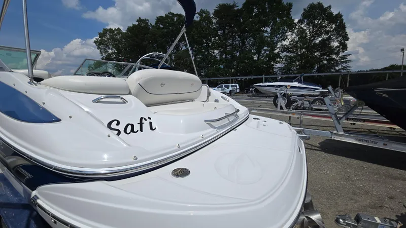 Slide: The Image of 2007 Crownline 220EX boat on trailer, sunny day, trees in background. - 10