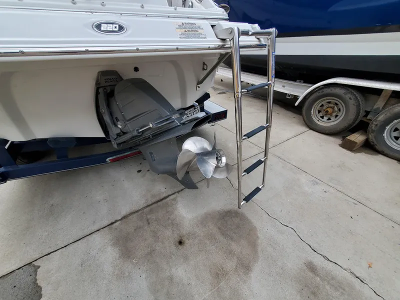 Slide: The Image of 2007 Crownline 220EX boat stern with propeller and ladder on trailer. - 11