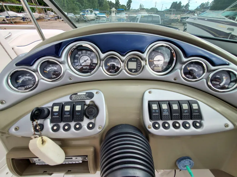 Slide: The Image of Dashboard of a 2007 Crownline 220EX boat with gauges and controls. - 15