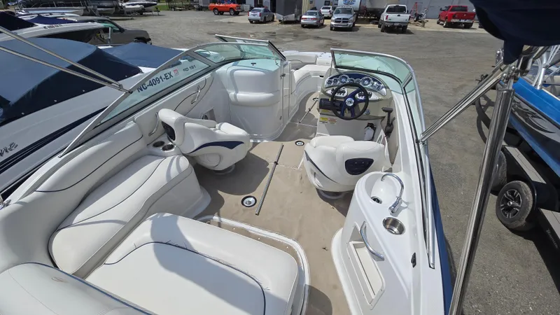 Slide: The Image of 2007 Crownline 220EX boat interior with white seating and steering console. - 19