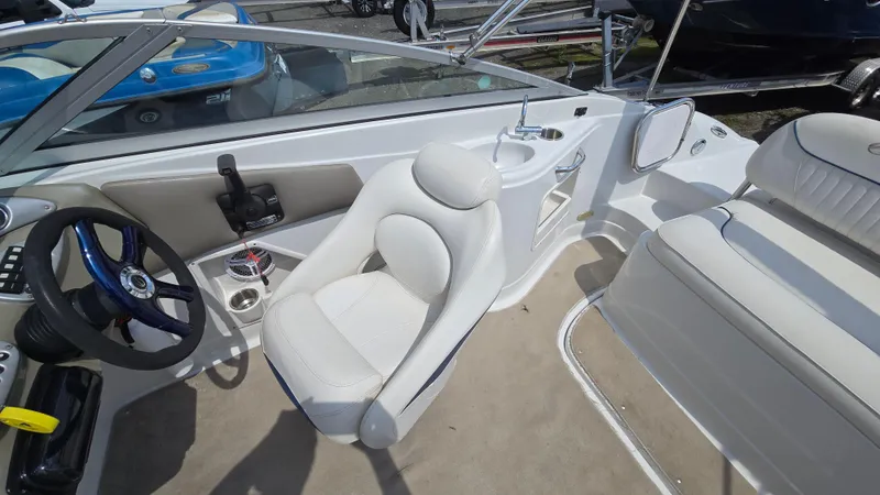 Slide: The Image of 2007 Crownline 220EX boat interior with steering wheel, seating, and sink. - 22