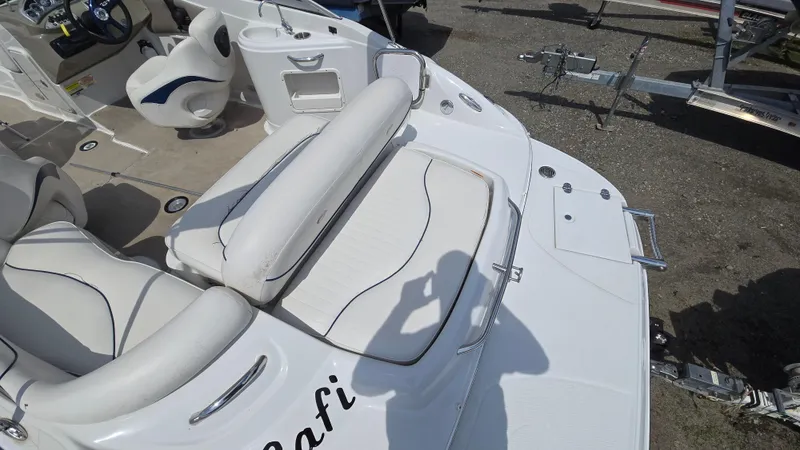 Slide: The Image of 2007 Crownline 220EX boat interior with white seating and steering area. - 24
