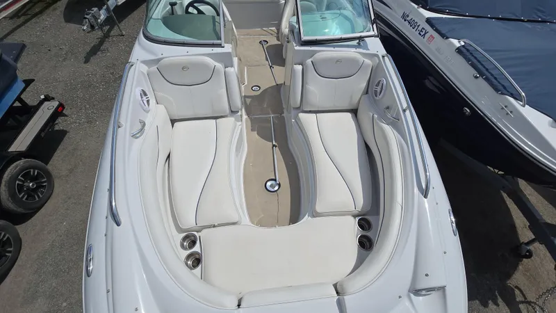 Slide: The Image of 2007 Crownline 220EX boat interior with white seating and cup holders. - 26