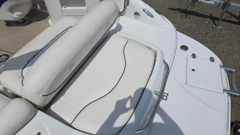 Slide: The Image of 2007 Crownline 220EX boat interior with white seating and deck details. - 30