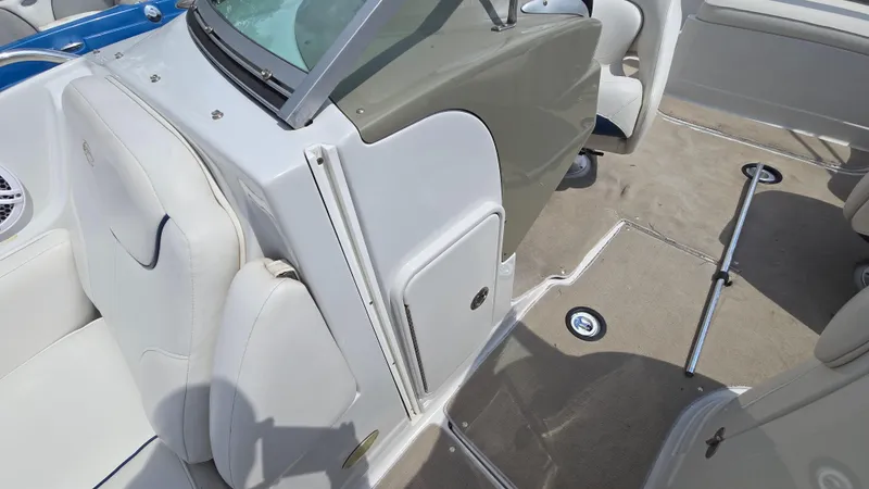 Slide: The Image of 2007 Crownline 220EX boat interior with white seating and beige flooring. - 31