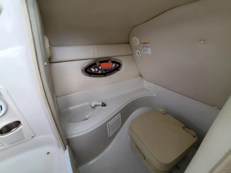 Slide: The Image of 2007 Crownline 220EX boat interior with compact bathroom amenities. - 34