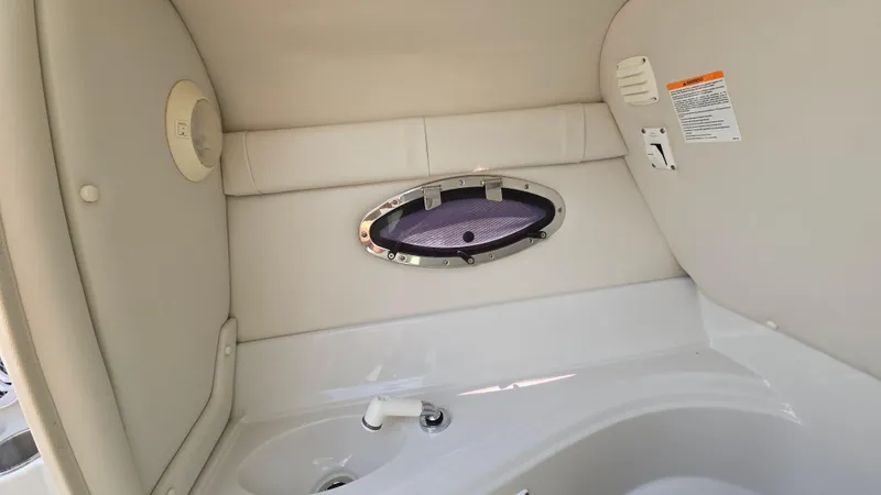 Slide: The Image of Interior of 2007 Crownline 220EX boat, featuring a small window and sink area. - 35