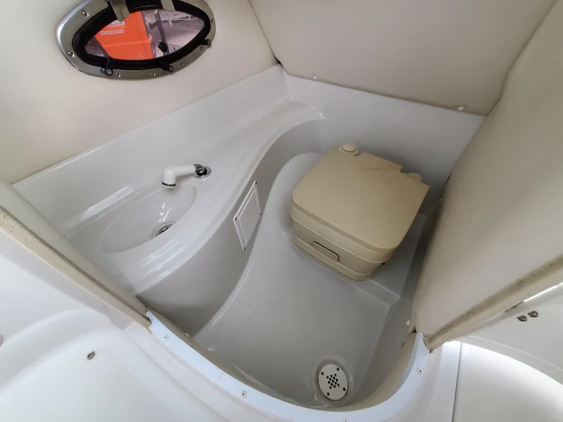 Slide: The Image of 2007 Crownline 220EX boat interior with compact toilet and sink. - 36