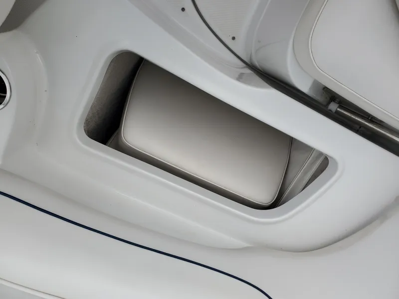 Slide: The Image of 2007 Crownline 220EX boat interior storage compartment with cushioned seating. - 37