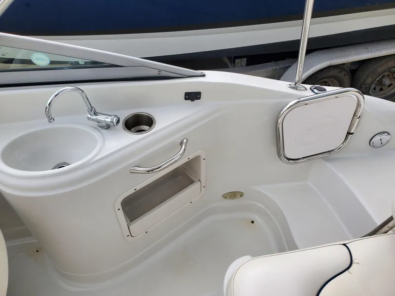 Slide: The Image of 2007 Crownline 220EX boat interior with sink and storage compartment. - 38