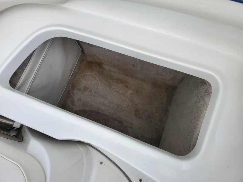 Slide: The Image of Storage compartment in 2007 Crownline 220EX boat, featuring white interior design. - 39