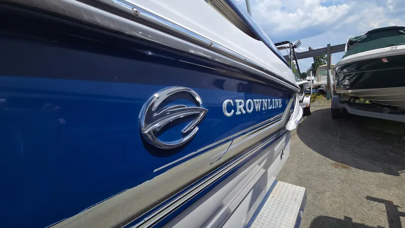 Slide: The Image of 2007 Crownline 220EX boat with blue and white exterior, parked outdoors. - 4