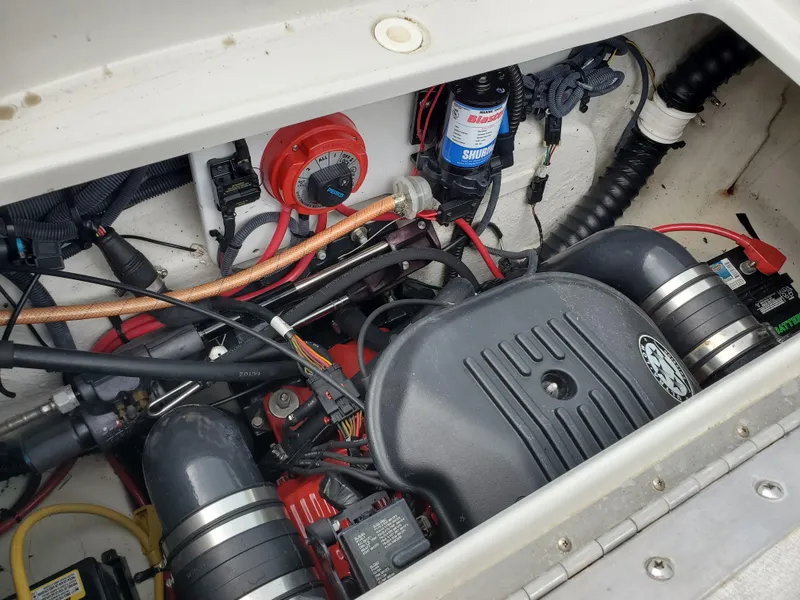 Slide: The Image of Engine compartment of a 2007 Crownline 220EX boat, showcasing various mechanical components. - 42