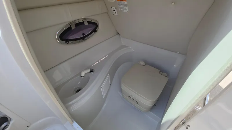 Slide: The Image of 2007 Crownline 220EX boat interior with compact bathroom and sink. - 44