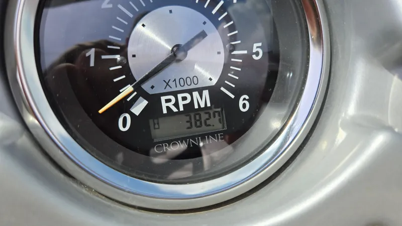 Slide: The Image of Close-up of a 2007 Crownline 220EX RPM gauge showing 382.7 hours. - 49