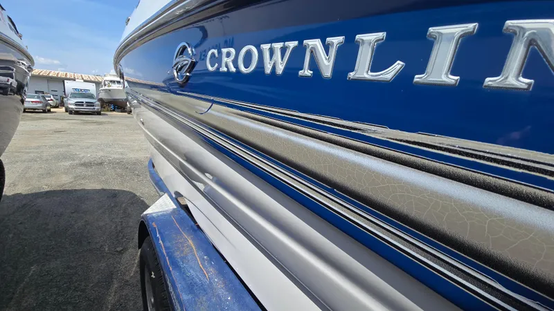 Slide: The Image of 2007 Crownline 220EX boat, blue and white exterior, parked outdoors. - 5