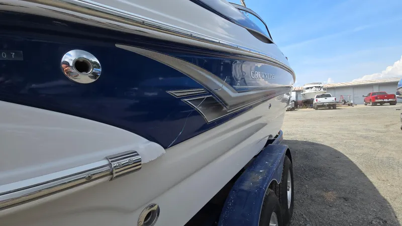 Slide: The Image of 2007 Crownline 220EX boat on trailer, side view, in a boatyard. - 6