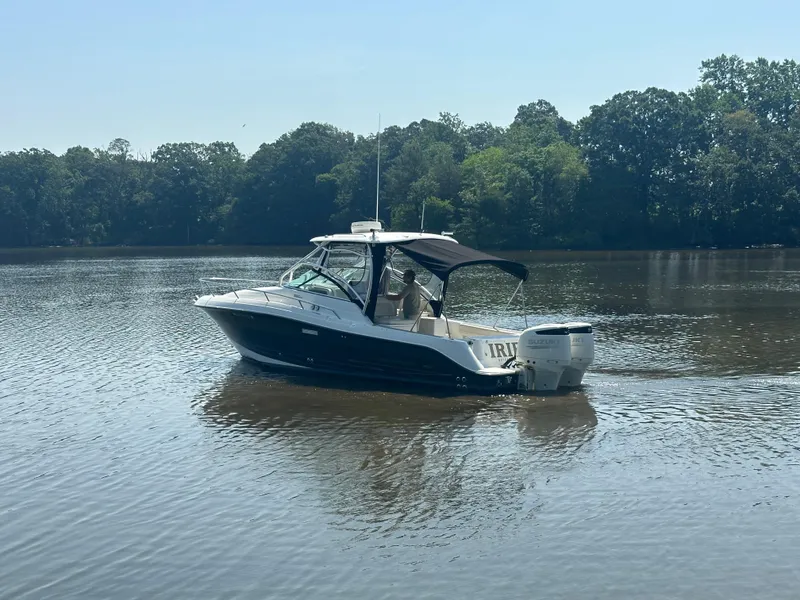 Slide: The Image of 2006 Hydra-Sports Vector 2900 VX boat cruising on a calm lake with forested shoreline. - 1