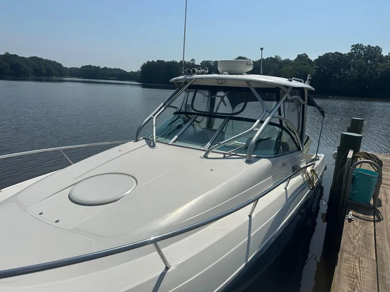 Slide: The Image of 2006 Hydra-Sports Vector 2900 VX boat docked by a serene lake. - 11