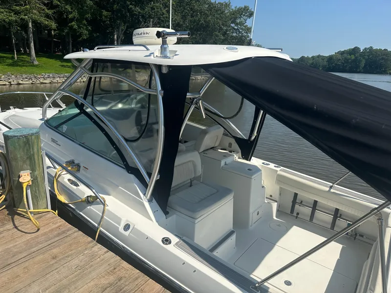 Slide: The Image of 2006 Hydra-Sports Vector 2900 VX boat docked, featuring sleek design and spacious seating. - 12