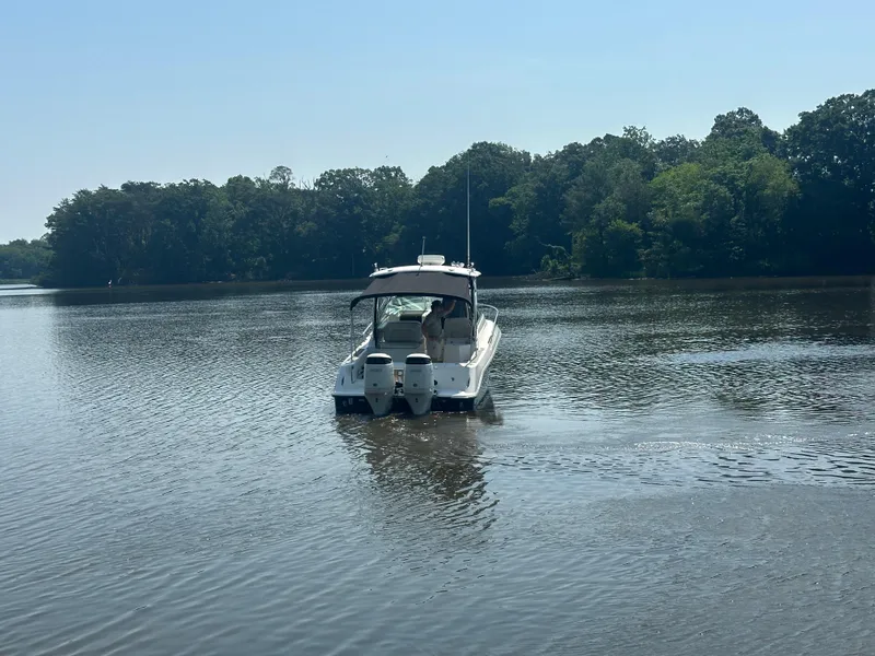 Slide: The Image of 2006 Hydra-Sports Vector 2900 VX boat on calm lake with forested shoreline. - 2