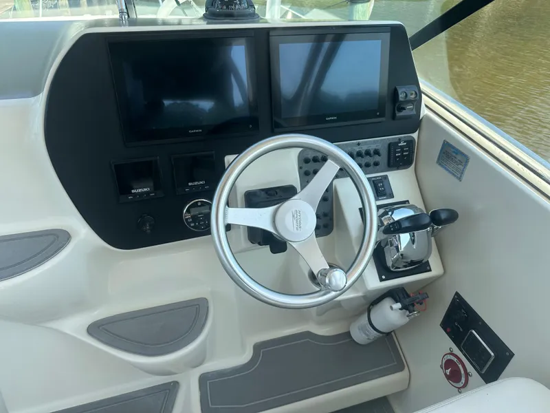 Slide: The Image of 2006 Hydra-Sports Vector 2900 VX helm with dual Garmin displays and Suzuki controls. - 23