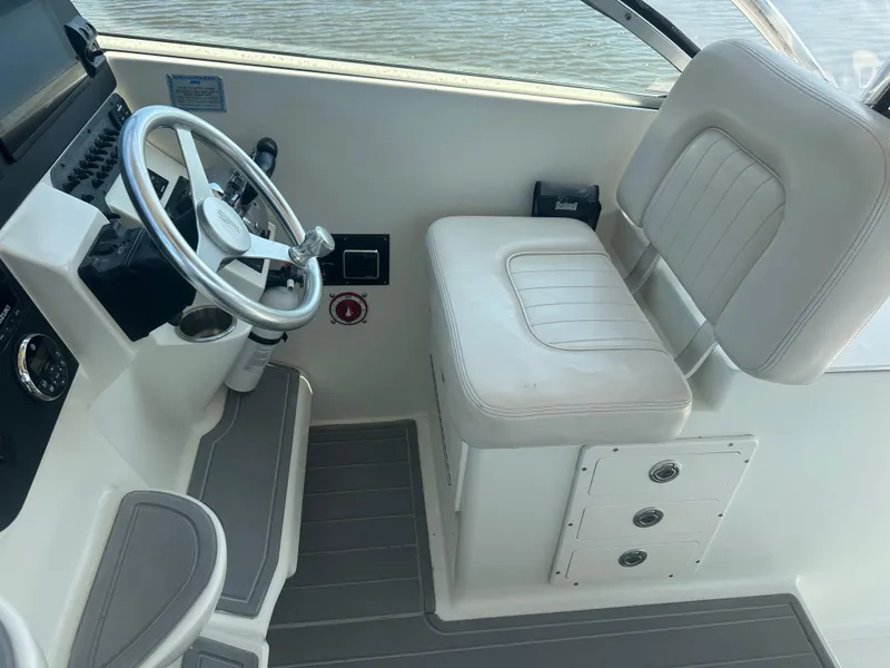 Slide: The Image of 2006 Hydra-Sports Vector 2900 VX helm with steering wheel and cushioned seat. - 25