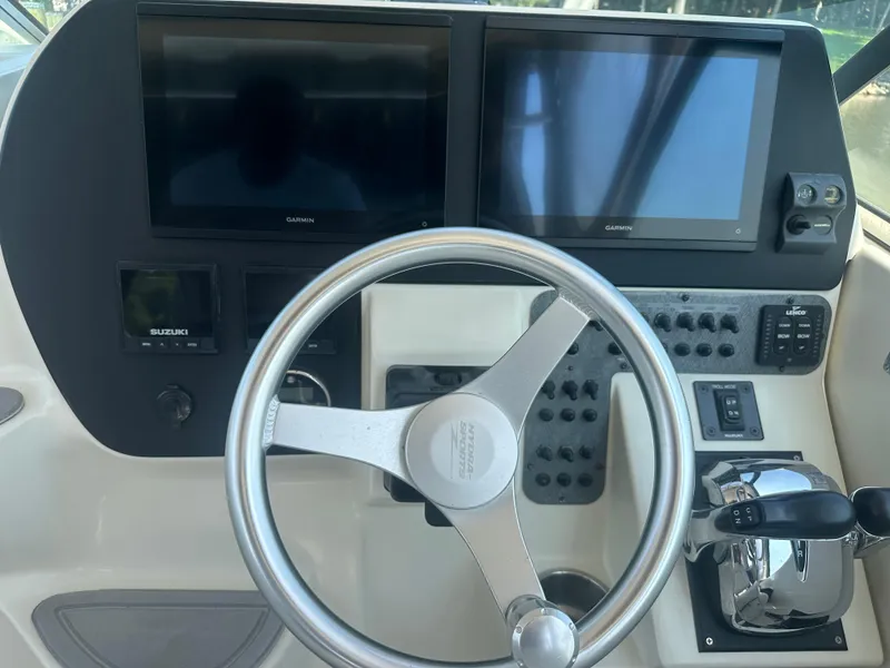 Slide: The Image of 2006 Hydra-Sports Vector 2900 VX dashboard with Garmin displays and steering wheel. - 27
