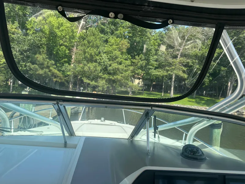Slide: The Image of 2006 Hydra-Sports Vector 2900 VX boat cockpit view with lush green shoreline. - 28