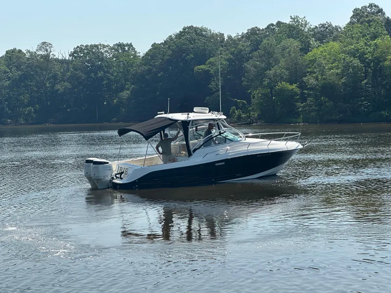 Slide: The Image of 2006 Hydra-Sports Vector 2900 VX boat on calm water, surrounded by lush trees. - 3