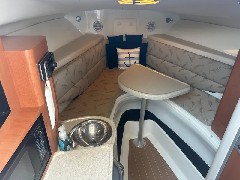 Slide: The Image of 2006 Hydra-Sports Vector 2900 VX cabin interior with seating, table, and kitchenette. - 30