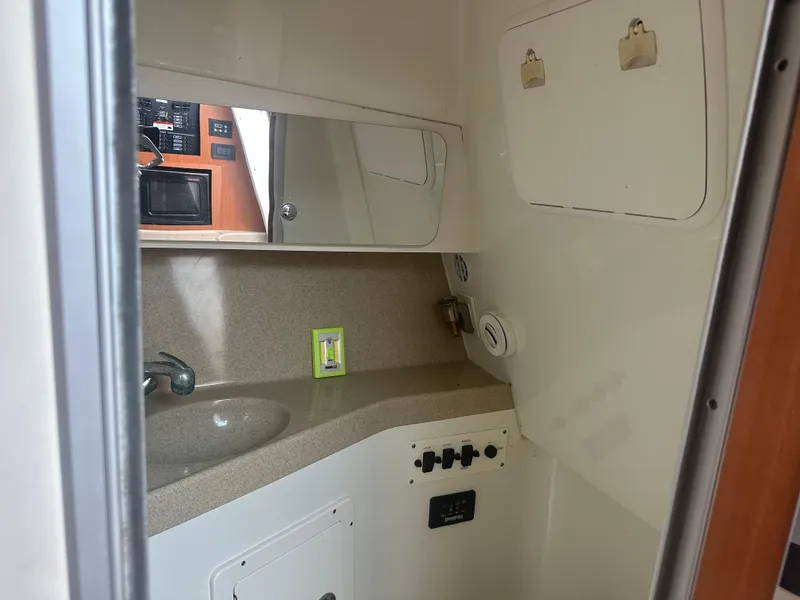Slide: The Image of 2006 Hydra-Sports Vector 2900 VX cabin interior with sink and control panel. - 35